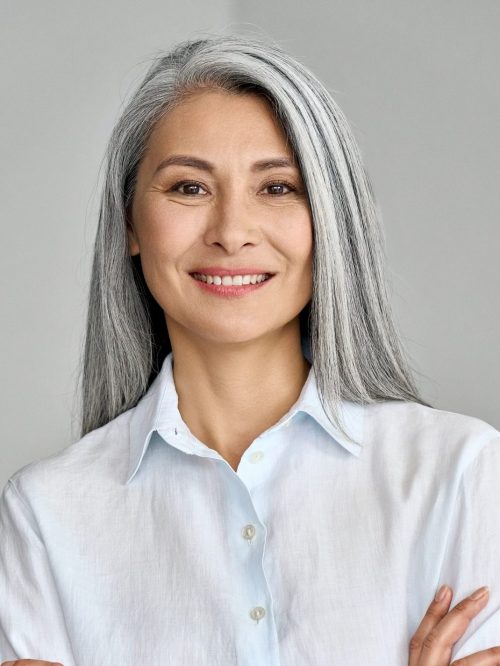 vertical-portrait-of-mature-50-years-asian-business-woman-on-grey-background--e1623738911734.jpg
